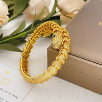 Gold pavé serpent head bracelet with scale-inspired links